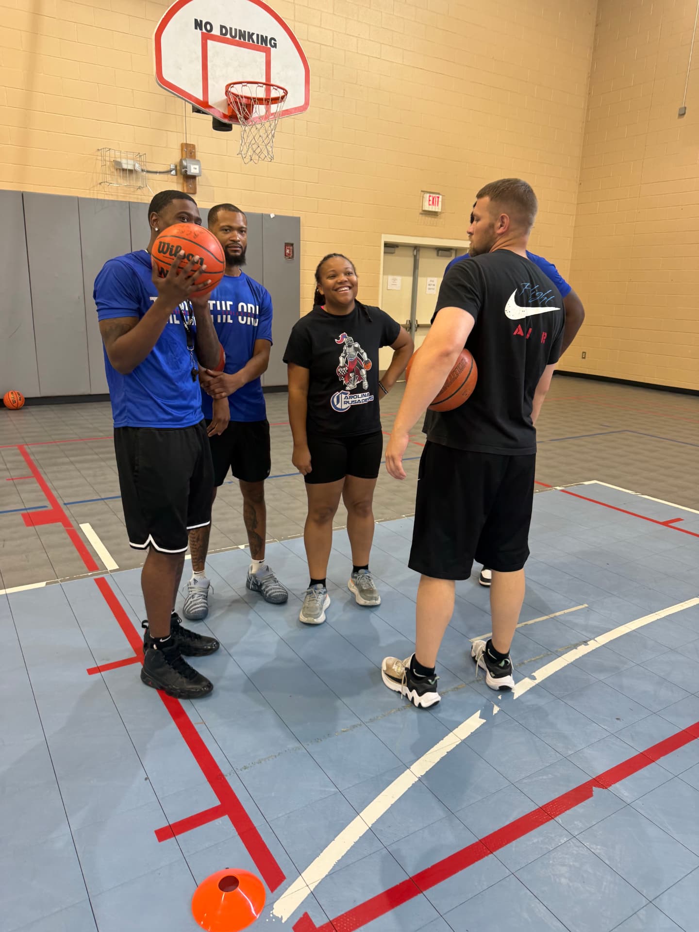 Coaches talking on the court during the Richland County Fall Mini Camp